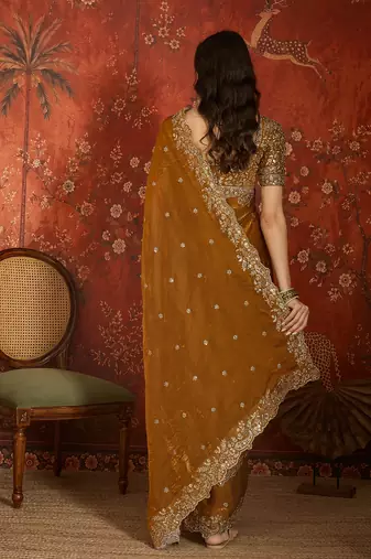 Gold tissue satin embroidered saree with unstitched blouse piece.