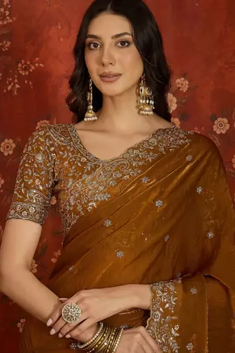 Gold tissue satin embroidered saree with unstitched blouse piece.