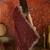 Maroon tissue satin embroidered saree with unstitched blouse piece.