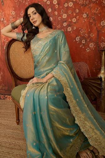 Sky blue tissue satin embroidered saree with unstitched blouse piece.