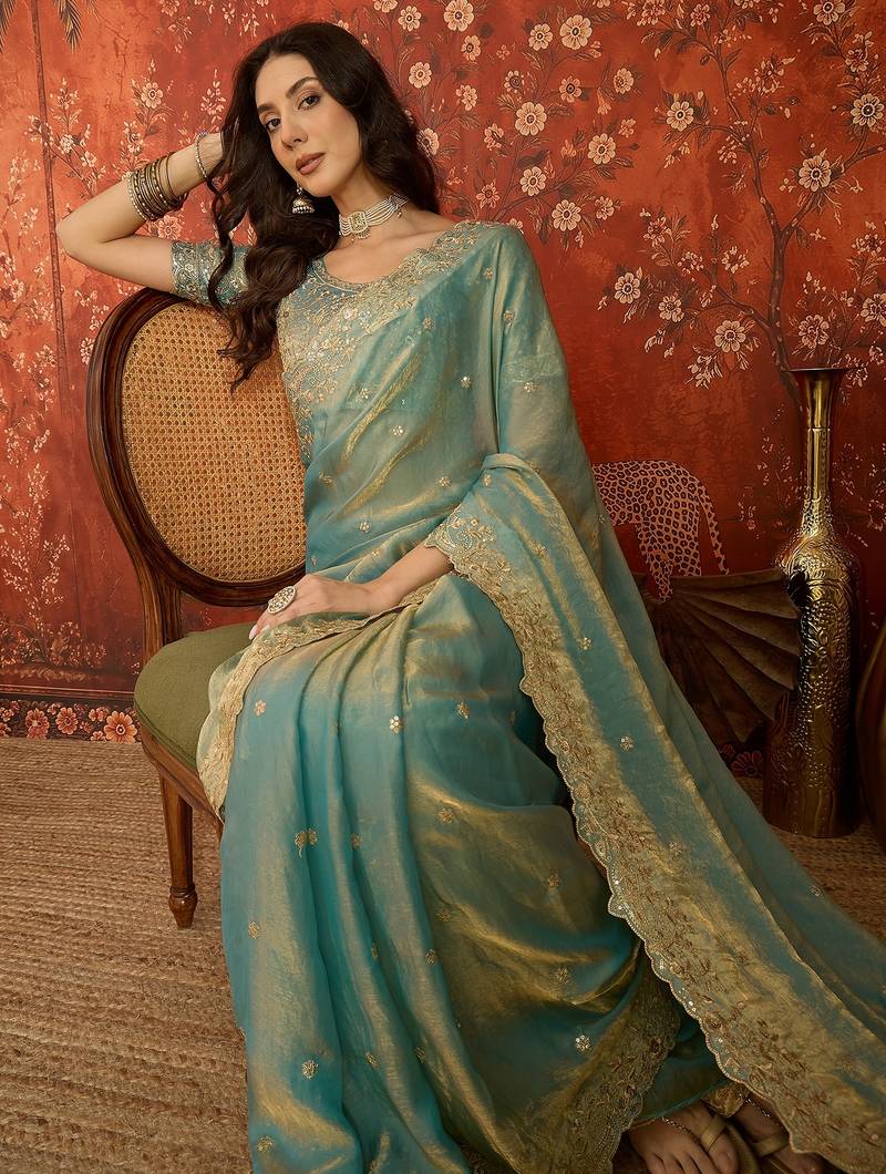 Sky blue tissue satin embroidered saree with unstitched blouse piece.