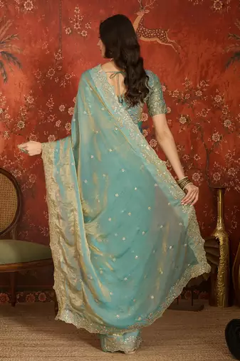 Sky blue tissue satin embroidered saree with unstitched blouse piece.