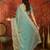 Sky blue tissue satin embroidered saree with unstitched blouse piece.