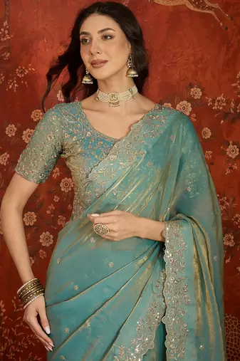 Sky blue tissue satin embroidered saree with unstitched blouse piece.
