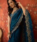 Teal tissue satin embroidered saree with unstitched blouse piece.