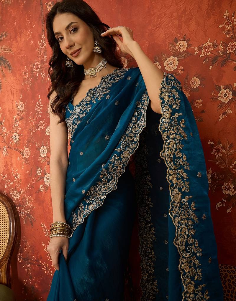 Teal tissue satin embroidered saree with unstitched blouse piece.