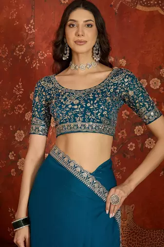 Teal tissue satin embroidered saree with unstitched blouse piece.