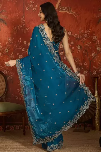 Teal tissue satin embroidered saree with unstitched blouse piece.