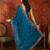 Teal tissue satin embroidered saree with unstitched blouse piece.