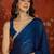 Teal tissue satin sequins saree with unstitched blouse piece.