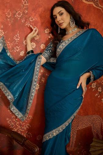 Teal tissue satin embroidered saree with unstitched blouse piece.