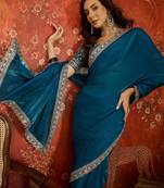 Teal tissue satin embroidered saree with unstitched blouse piece.