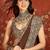 Brown silk blend crepe printed saree with unstitched blouse piece.