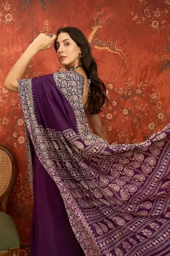 Purple silk blend crepe printed saree with unstitched blouse piece.