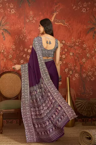 Purple silk blend crepe printed saree with unstitched blouse piece.