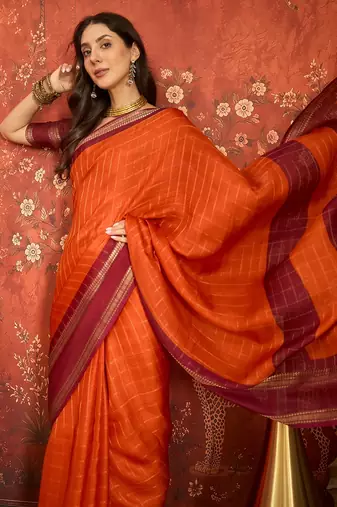 Orange silk cotton zari checks saree with unstitched blouse piece.