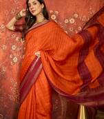 Orange silk cotton zari checks saree with unstitched blouse piece.
