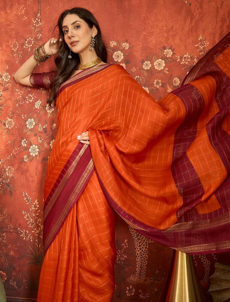 Orange silk cotton zari checks saree with unstitched blouse piece.