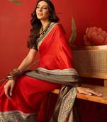 Red silk cotton zari checks saree with unstitched blouse piece.