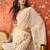 Cream chiffon embroidered saree with unstitched blouse piece.