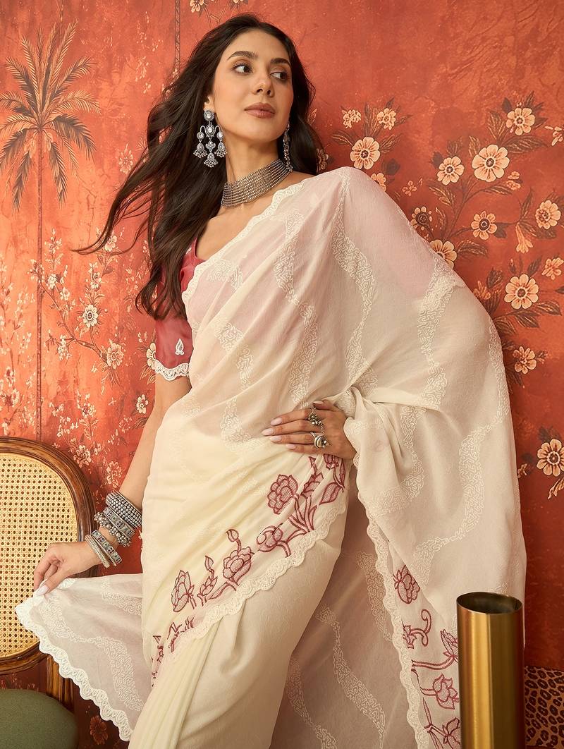 Cream chiffon embroidered saree with unstitched blouse piece.