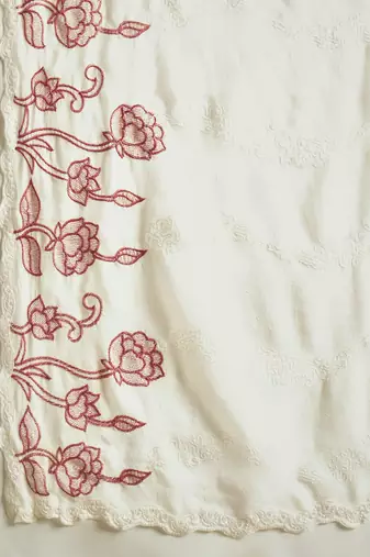 Cream chiffon embroidered saree with unstitched blouse piece.