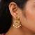 Gold plated designer chandbali earrings with ruby green stones & pearl drops