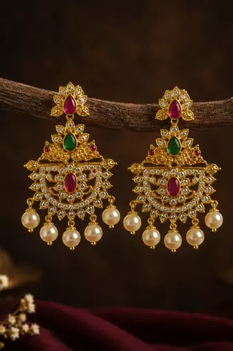 Gold plated designer chandbali earrings with ruby green stones & pearl drops