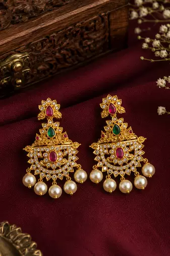 Gold plated designer chandbali earrings with ruby green stones & pearl drops