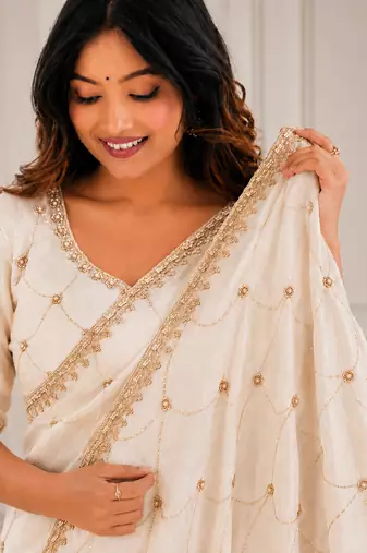 catching off-white embroidery work with real bits work fendy satin indian saree