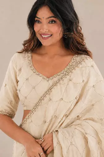 catching off-white embroidery work with real bits work fendy satin indian saree