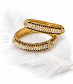 Gold-toned pearl bangle set with ruby & emerald stones set of 4 bangles, traditional design, festive wear.