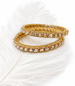 Gold-toned pearl bangle set with ruby & emerald stones set of 4 bangles, traditional design, festive wear.