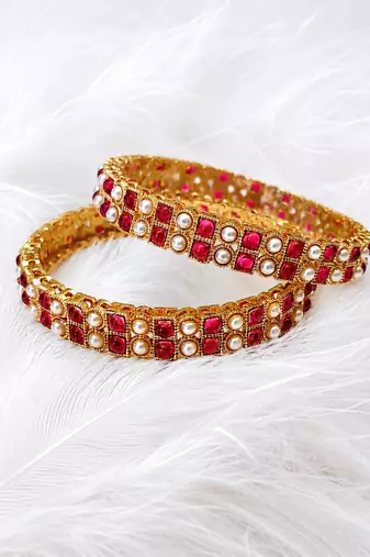 Gold-toned pearl bangle set with ruby & emerald stones