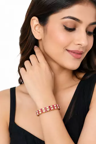 Gold-toned pearl bangle set with ruby & emerald stones