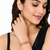 Gold-toned pearl bangle set with ruby & emerald stones