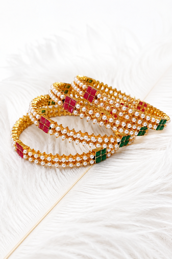 Gold-toned pearl bangle set with ruby & emerald stones set of 4 bangles, traditional design, festive wear.
