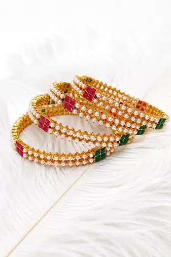 Gold-toned pearl bangle set with ruby & emerald stones set of 4 bangles, traditional design, festive wear.