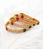 Gold-toned pearl bangle set with ruby & emerald stones set of 4 bangles, traditional design, festive wear.