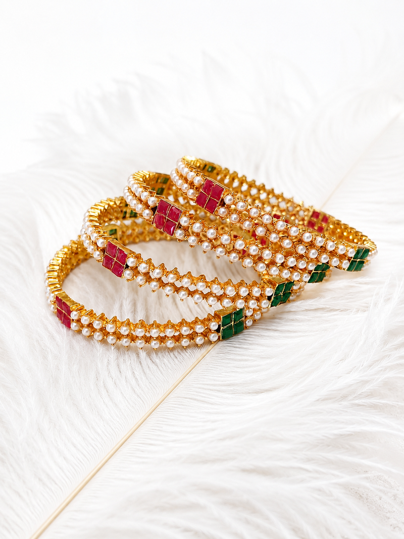 Gold-toned pearl bangle set with ruby & emerald stones set of 4 bangles, traditional design, festive wear.