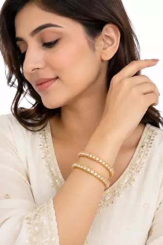 Gold-toned pearl bangle set with ruby & emerald stones set of 4 bangles, traditional design, festive wear.