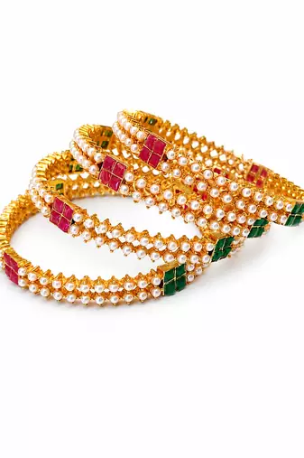 Gold-toned pearl bangle set with ruby & emerald stones set of 4 bangles, traditional design, festive wear.
