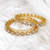 Gold-toned kundan bangles with teardrop stones, set of 2 filigree design, ethnic wear, white stone embellished.