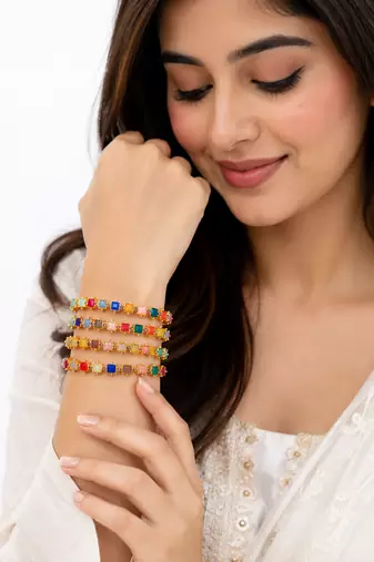Gold-toned kundan bangles with teardrop stones, set of 2 filigree design, ethnic wear, white stone embellished.