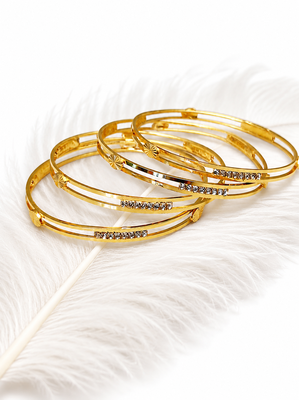 Gold-plated bangle set with crystal embellishments, set of 4 diamond-cut accents, women's jewellery, stackable design. 1