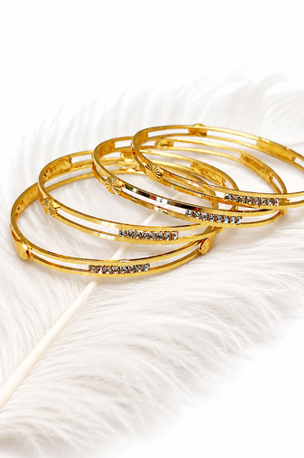Gold-plated bangle set with crystal embellishments, set of 4 diamond-cut accents, women's jewellery, stackable design.