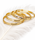 Gold-plated bangle set with crystal embellishments, set of 4 diamond-cut accents, women's jewellery, stackable design.