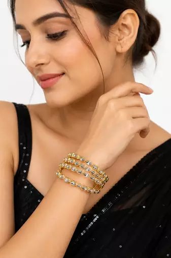 Gold-toned crystal bangles set of 4 for women kundan-style stones, stackable design, festive wear, hexagonal motifs.