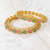 Gold-toned bangles with pink & green teardrop stones, set of 2 filigree design.