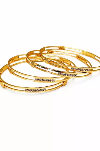 Gold-plated bangle set with crystal embellishments, set of 4 diamond-cut accents, women's jewellery, stackable design.